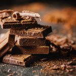 Closeup of dark chocolate bars and cocoa powder.